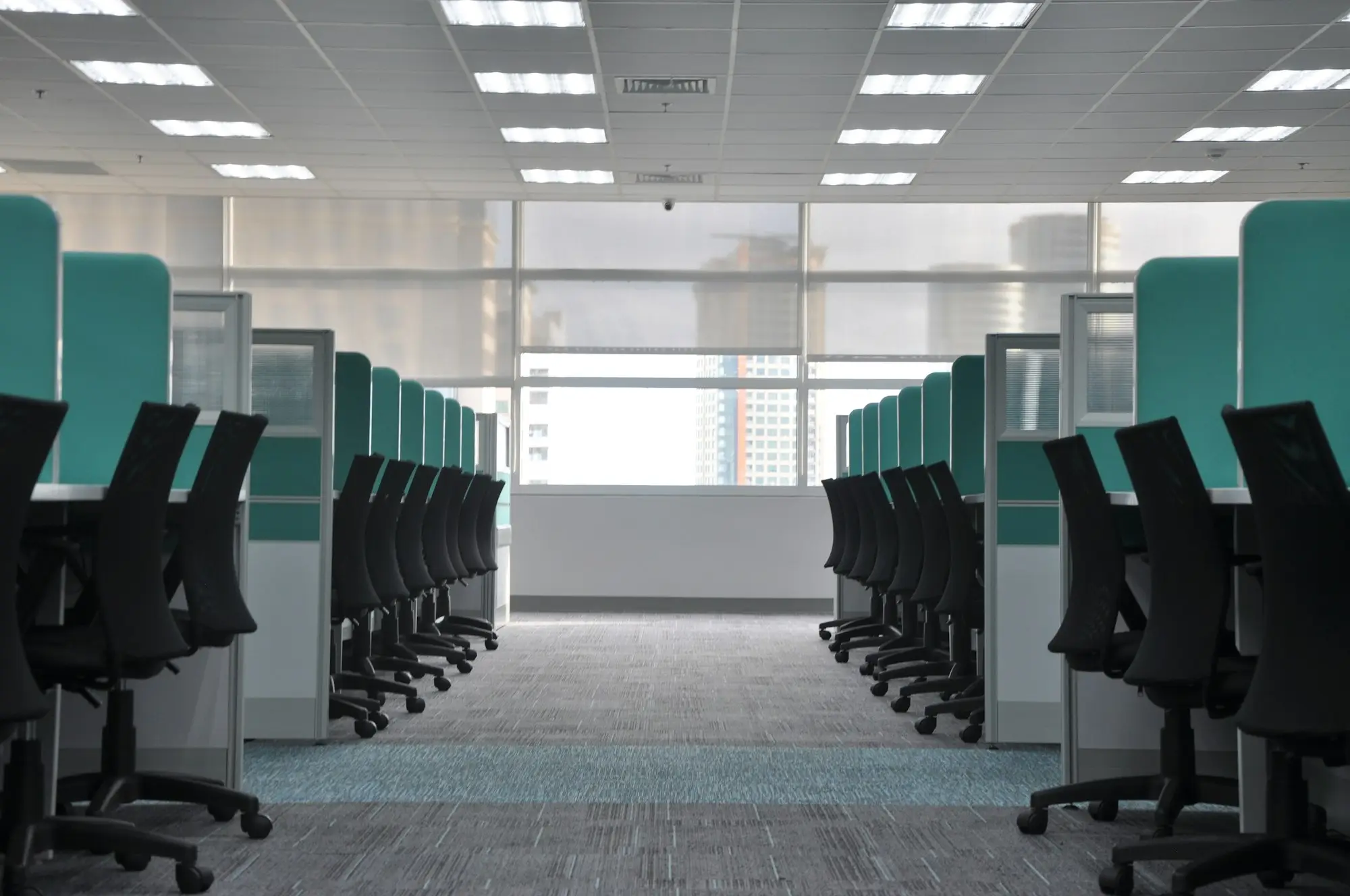Rows of empty office desks and chairs during a Christmas closedown, with the business shut for the summer break